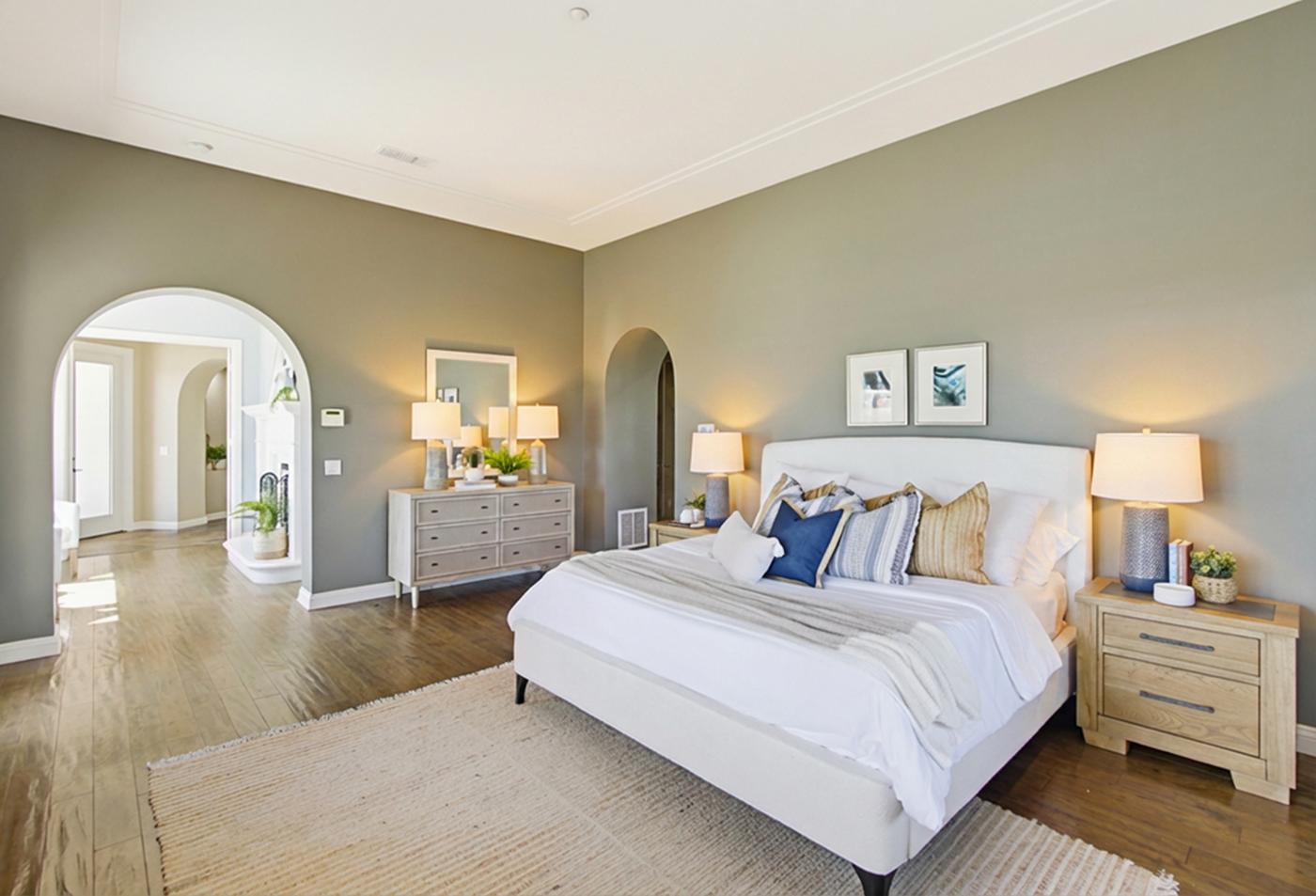 Santaluz staged primary bedroom sage green walls San Diego